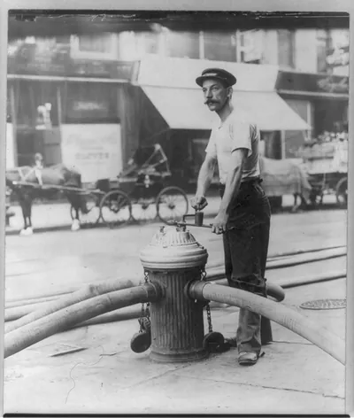 [New York City fireman turning on high pressure hoses at hydrant. July 1908]