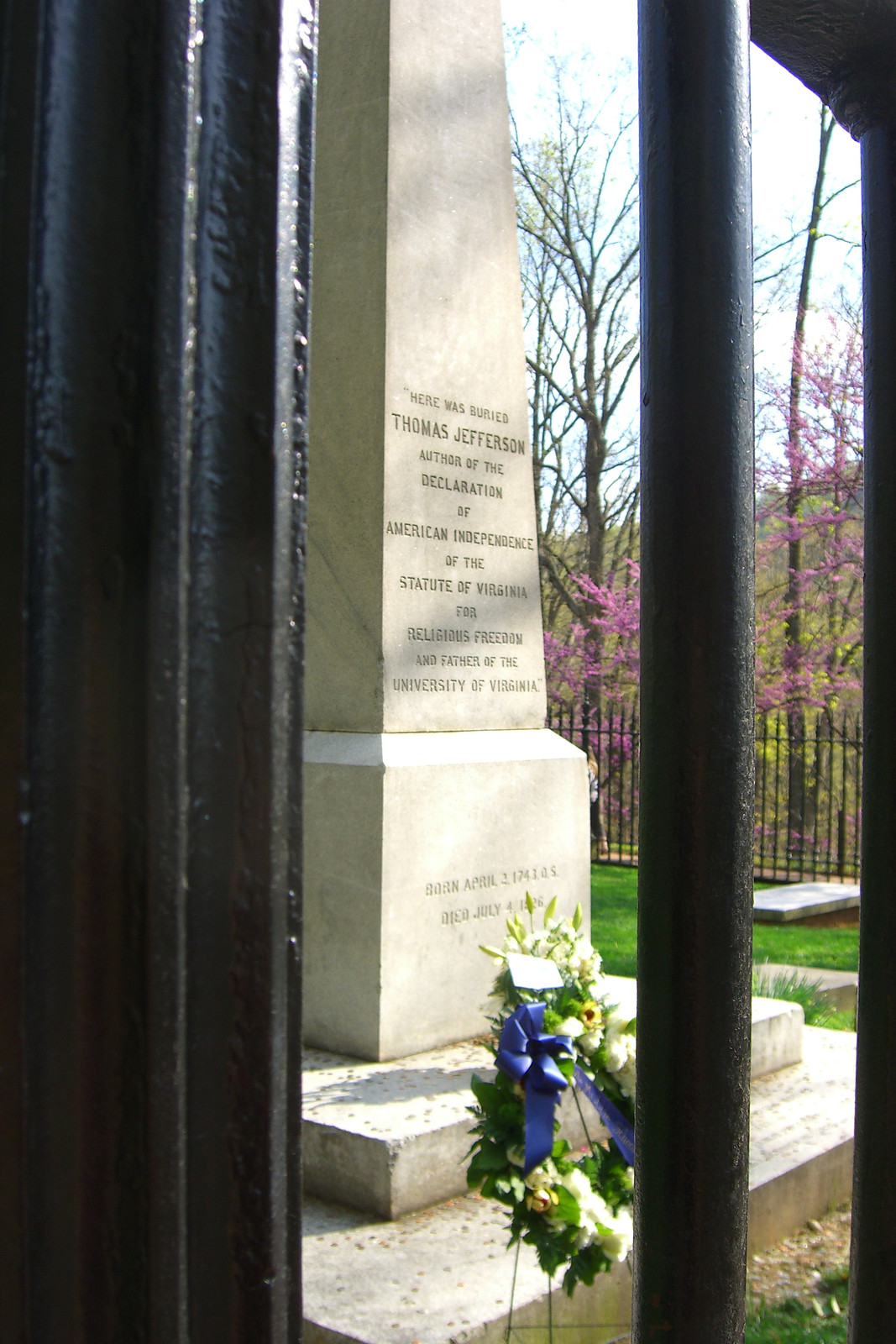 Thomas Jefferson's tombstone behind iron gate with wreath — historic image