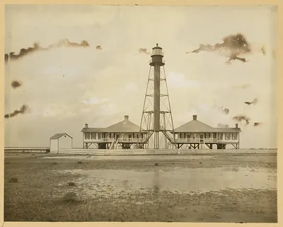 Lattice-tower lighthouse with keepers' houses, sepia photograph
