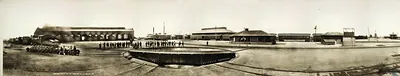 Panoramic view of railroad roundhouse and turntable