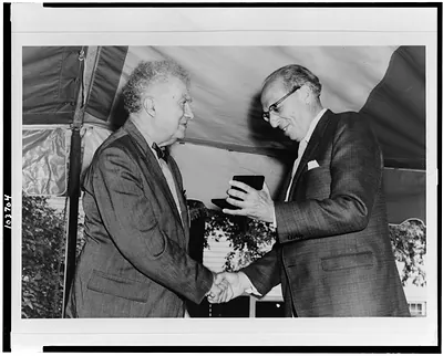 [Edgard Varese shaking hands with Aaron Copland, with Mr. Copland receiving presentation, standing, half-length] / Bernice B. Perry, Wilton, New Hampshire.
