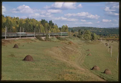 [Trans-Siberian Express speeds eastward beside mountain stream toward Vladivostok]