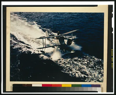 [Military seaplane with pilot and co-pilot taking off or landing on water]