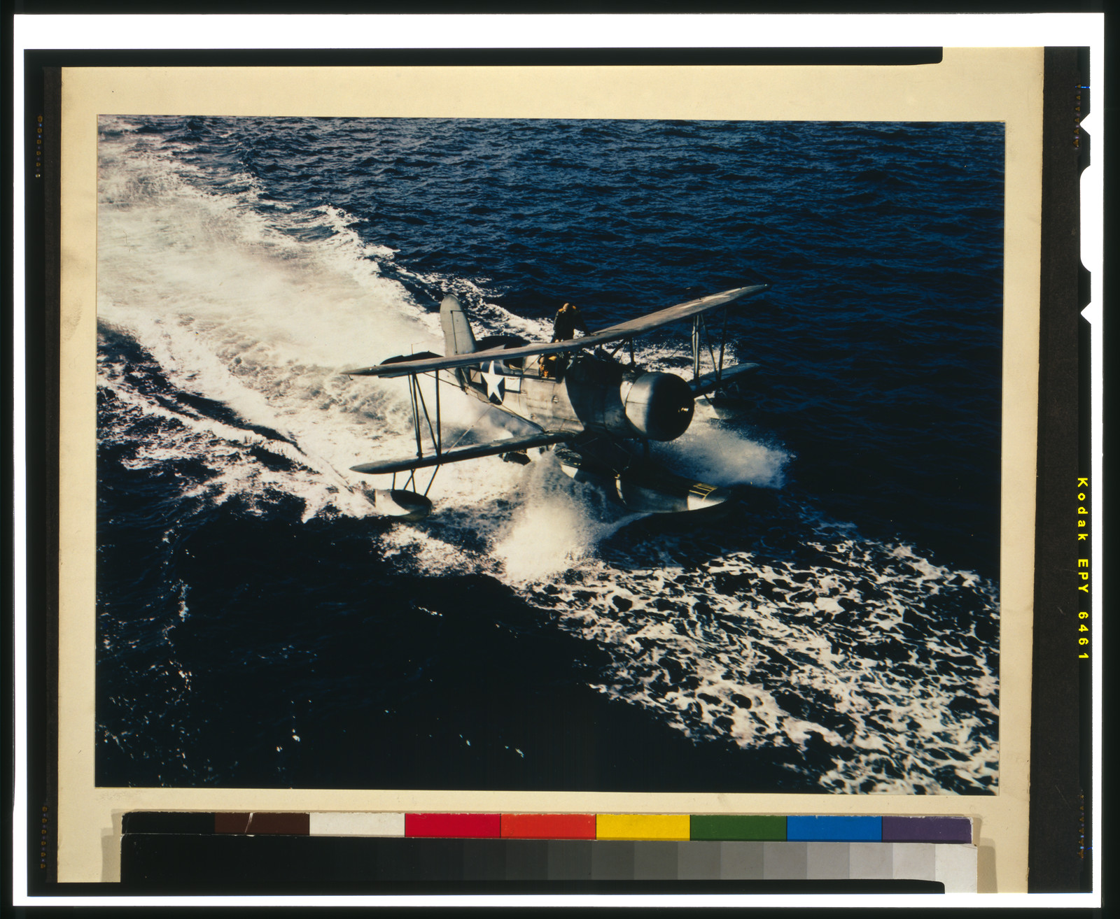 [Military seaplane with pilot and co-pilot taking off or landing on water], [between 1945 and 1947] — historic photograph