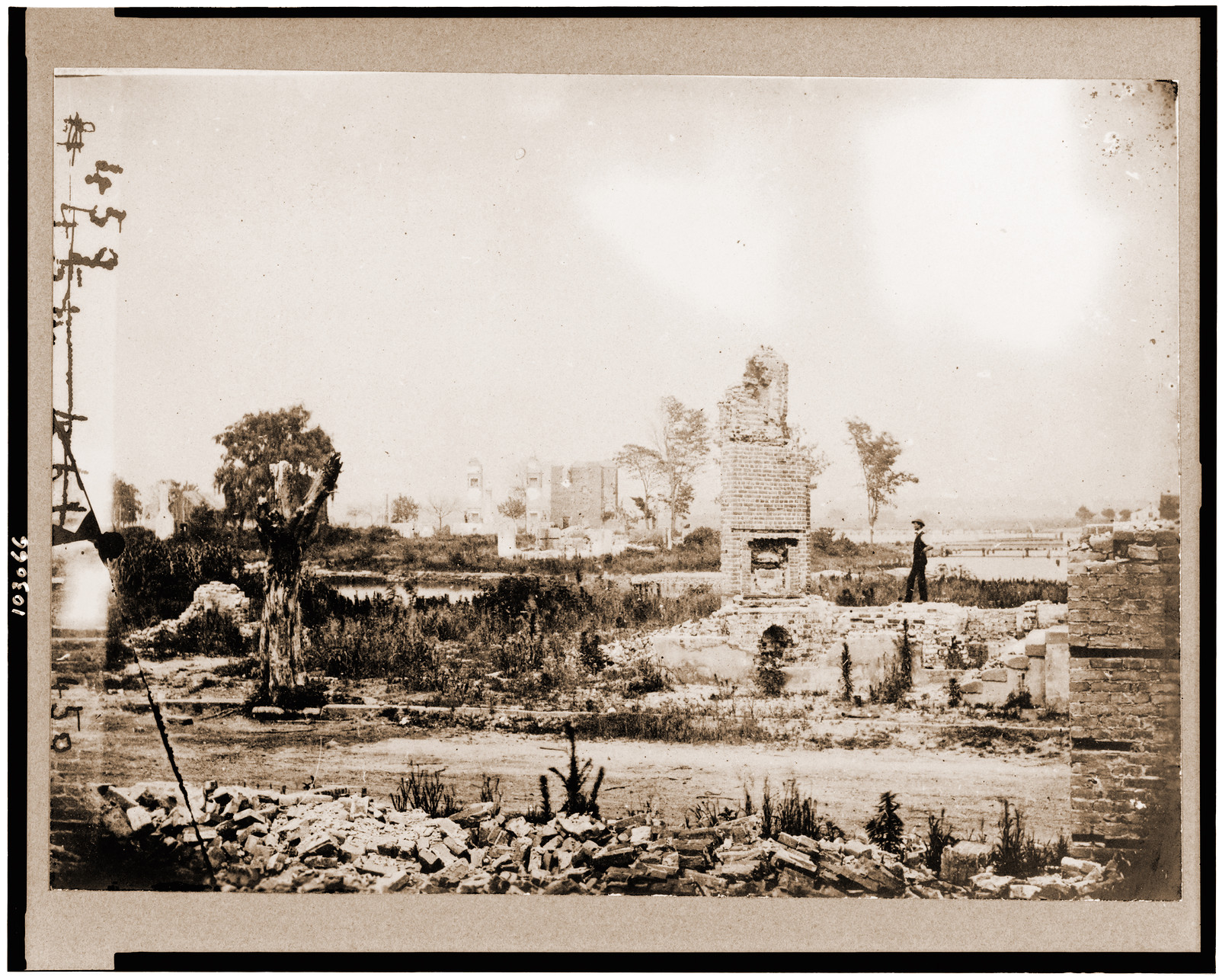 Ruins at Hampton Virginia showing chimneys and man standing, 1861 — historic photograph