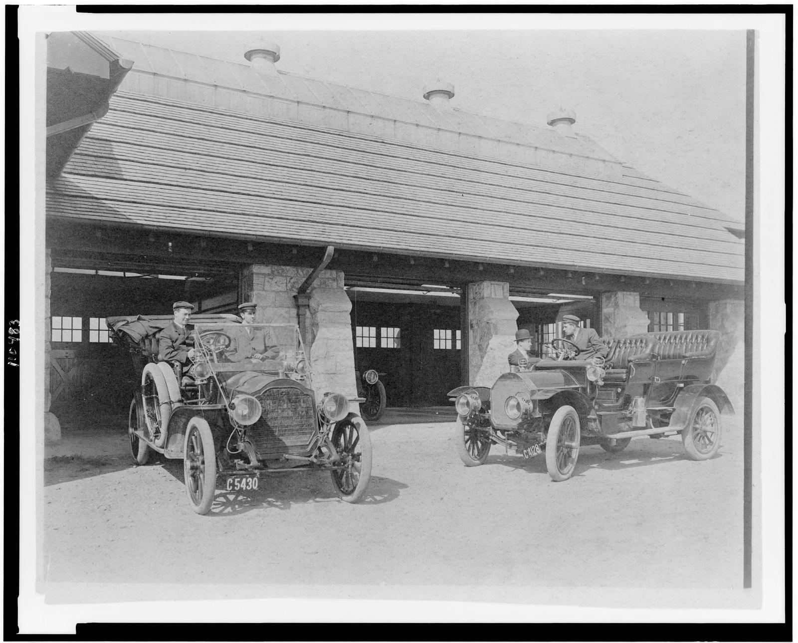 [Four men with two automobiles outside of garage of Edmund Cogswell Converse, Greenwich, Connecticut], [1908] — historic photograph