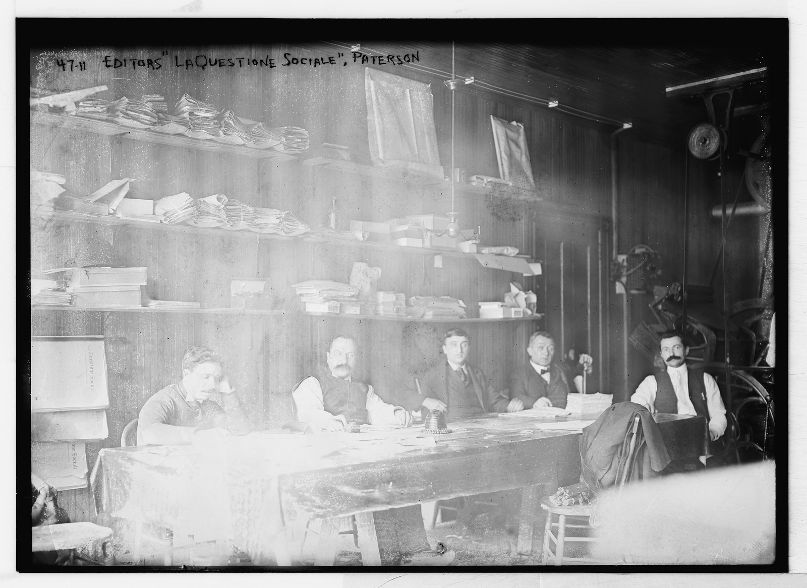 Editors of "La Questione Sociale", at table, Paterson, N.J., n/a — historic photograph