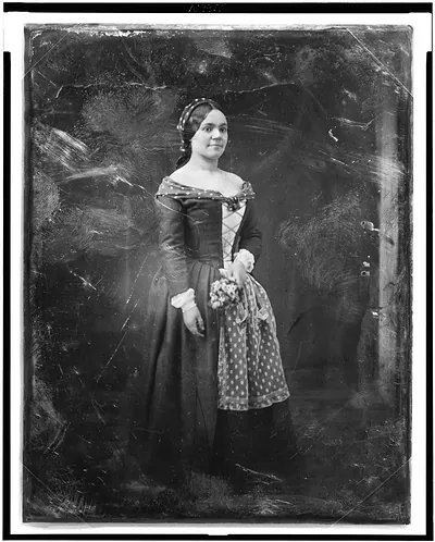 [Rosalie Henriette Bediez Laborde, full-length portrait of a woman, three-quarters to right, standing, in costume with lace apron, holding bouquet]