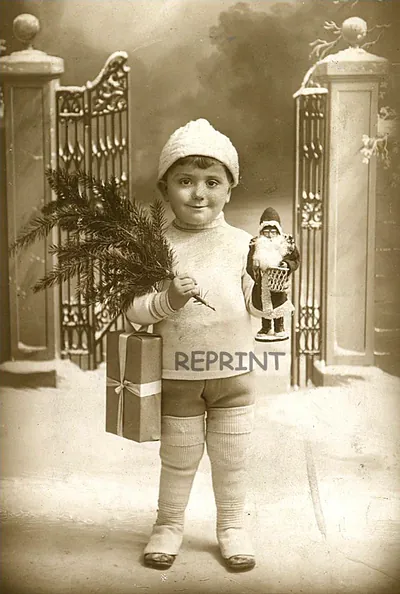 Child in winter hat holding Christmas tree and gift