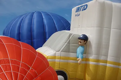 Hot air balloons beside an inflatable United Van Lines truck
