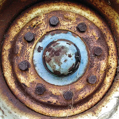 Close-up of a rusty wheel hub with lug nuts