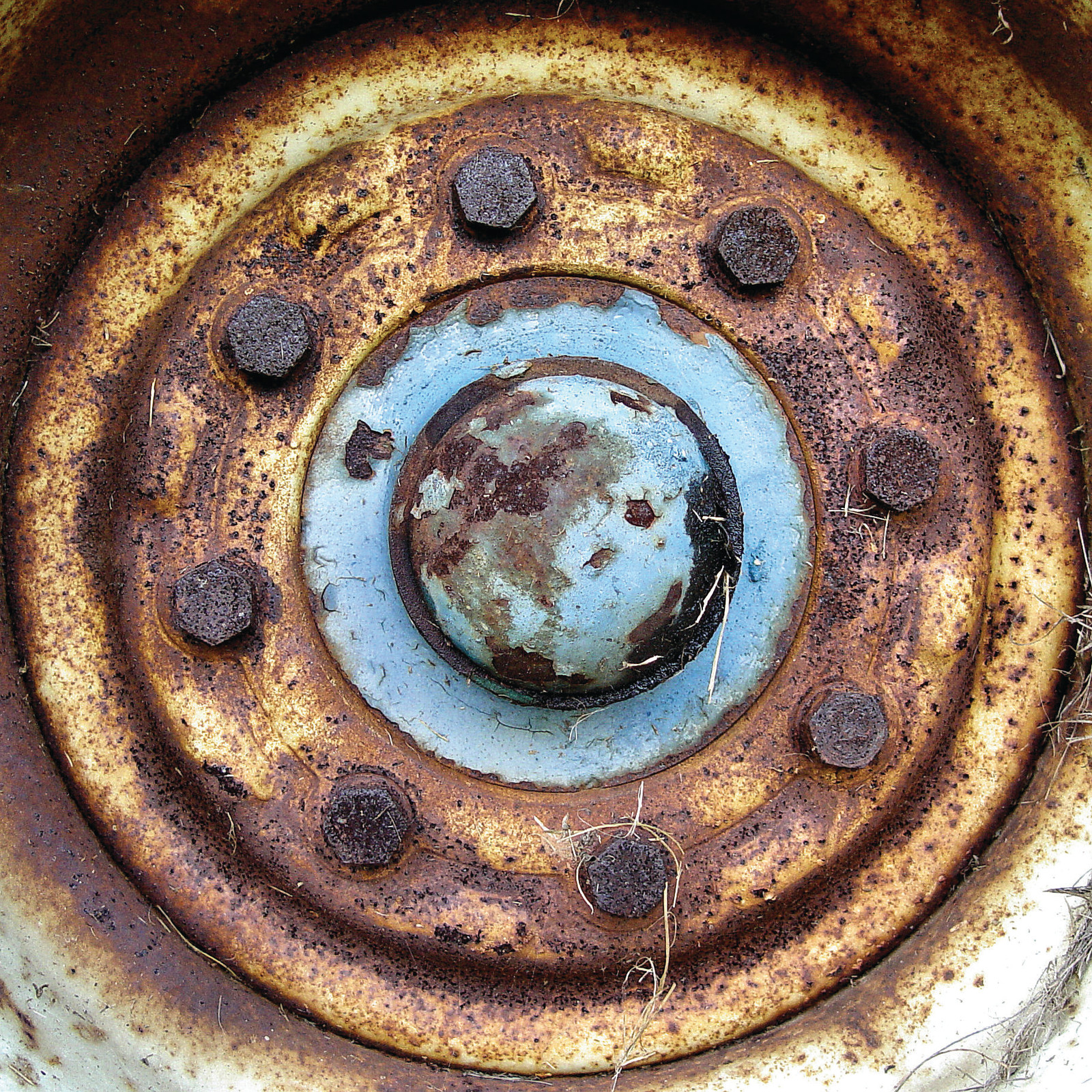 Close-up of a rusty wheel hub with lug nuts — historic image