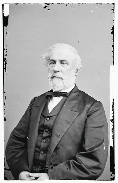 Studio portrait of a bearded man in dark suit