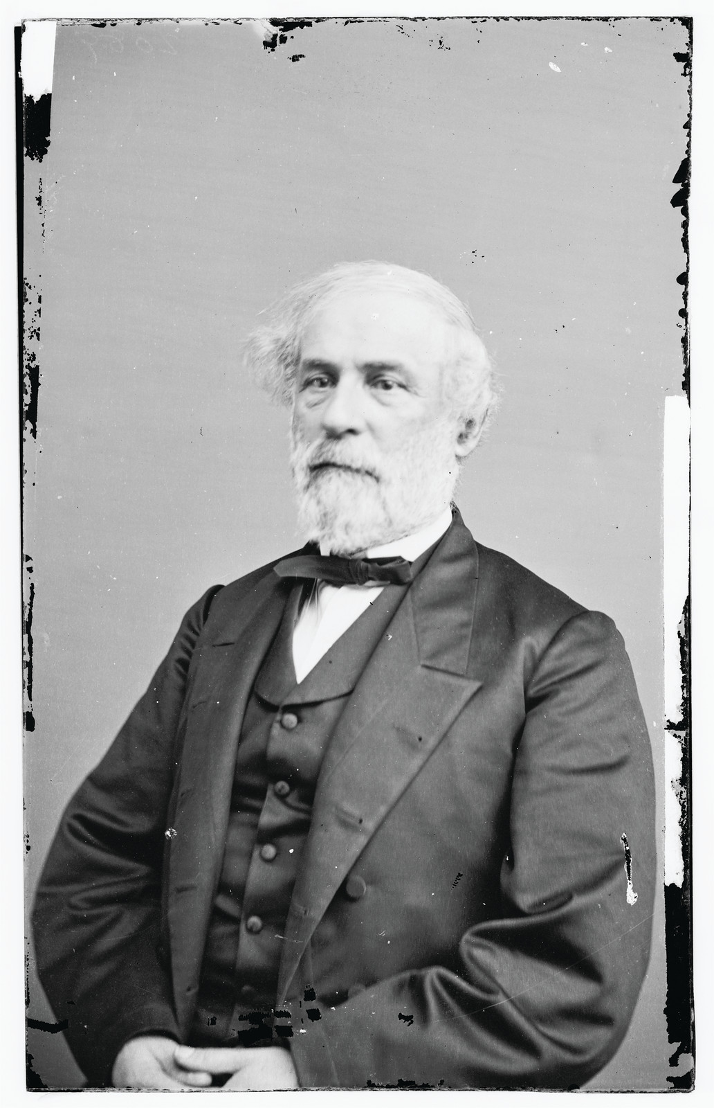 Studio portrait of a bearded man in dark suit — historic image
