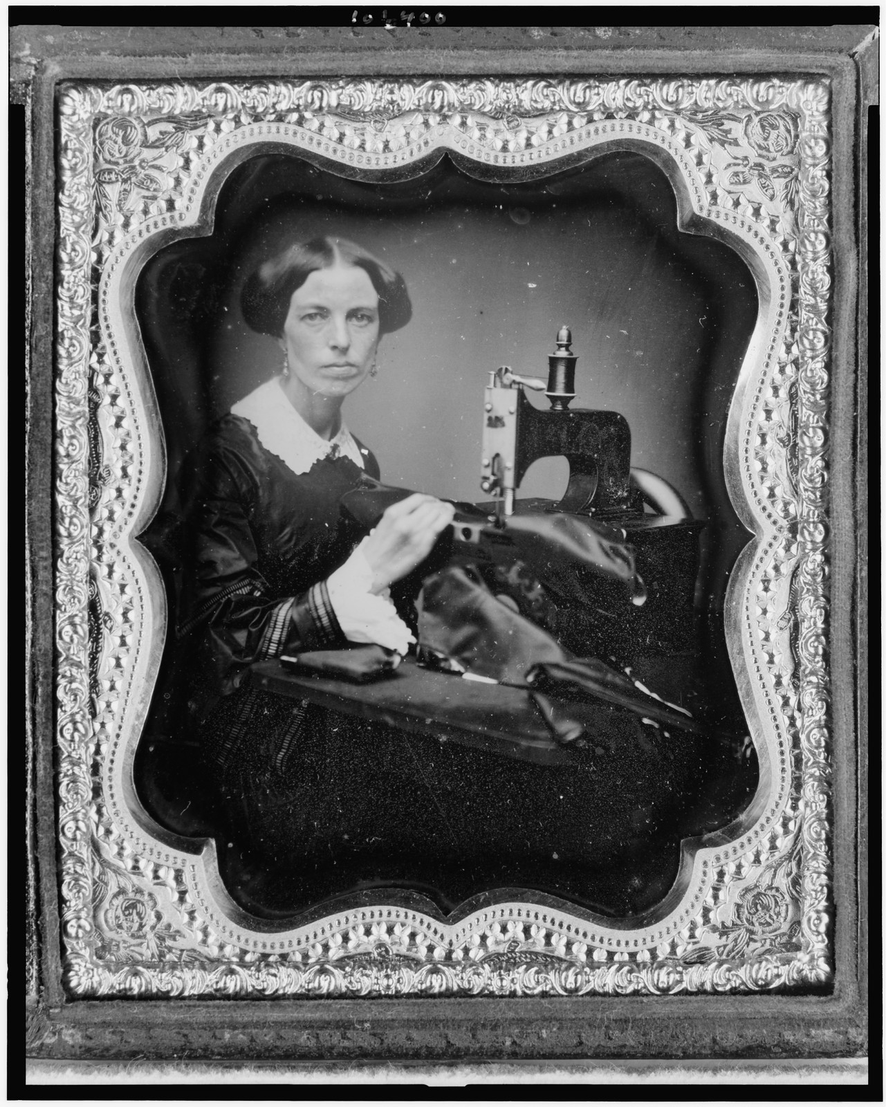 Seated woman posing with a sewing machine, daguerreotype, 1853 — historic photograph
