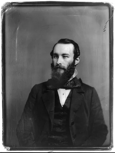 Bearded man in dark coat, studio portrait photograph