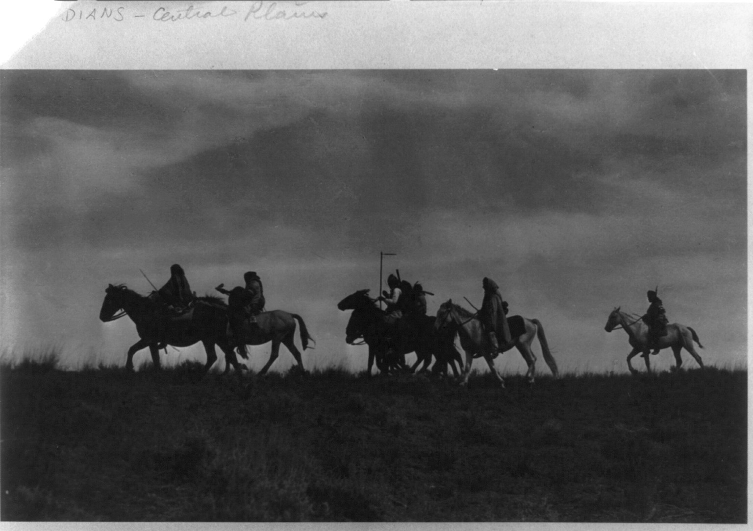 [Indian scouts on horseback passing under cover of night], c1913 April 30. — historic photograph
