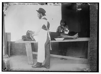 Dr. Secord, missionary doctor to Indians, with patient on table