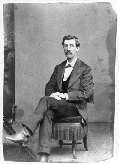 [Jeff Whitman, full-length portrait, seated, facing left]