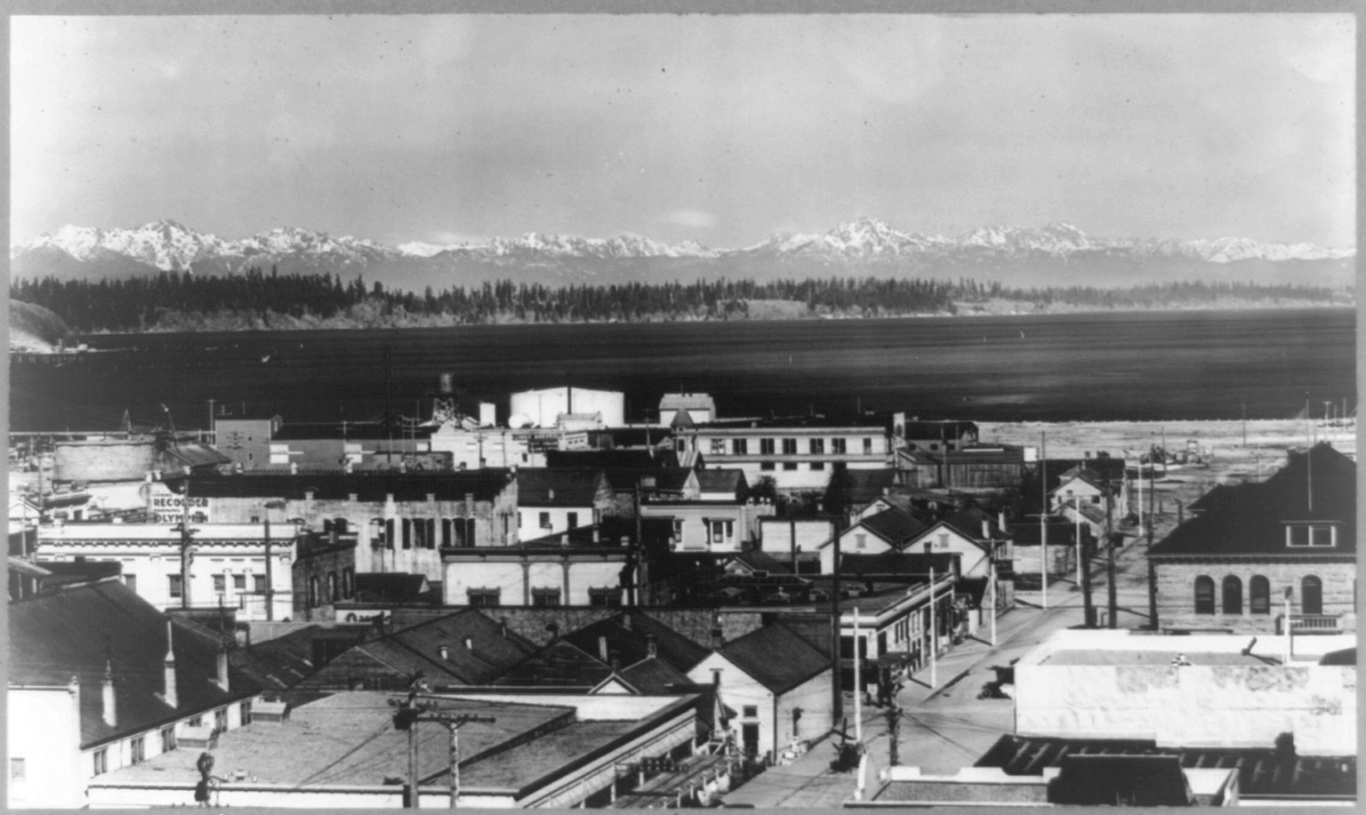 [Bird's-eye view of Olympia, Washington with snow-capped Olympic Range in background], c1916. — historic photograph