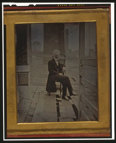 [John McAllister, Jr., full-length portrait, seated in a chair, outdoors on the roof of 48 Chestnut Street, Philadelphia]