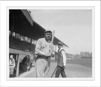 Baseball player with bat in Reds uniform, vintage photograph