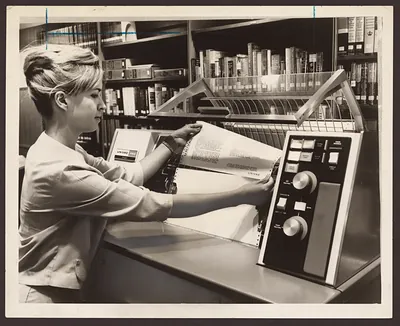 Woman operating a UNIVAC printer in a library