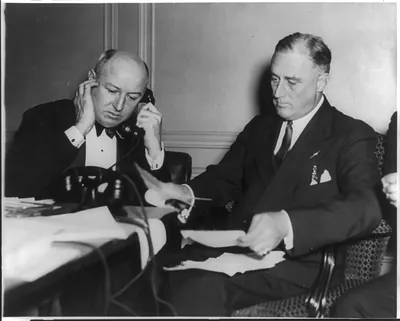 Gov. Franklin D. Roosevelt, Dem. nominee for Pres., receiving the election returns as James Farley, ..., answers phone at the Democratic National Headquarters in the Hotle Biltmore, New York City