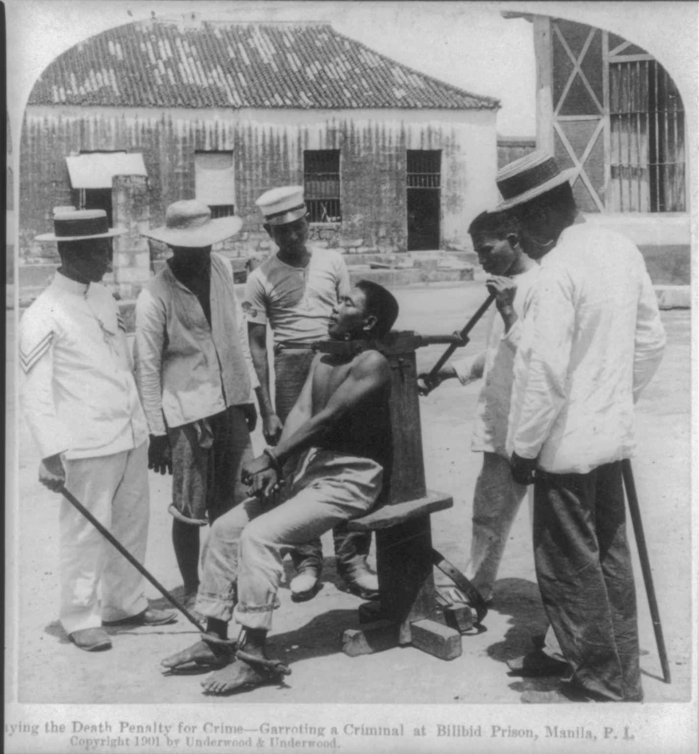 Paying the death penalty for crime - garroting a criminal at Bilibid Prison, Manila, P.I., c1901. — historic photograph