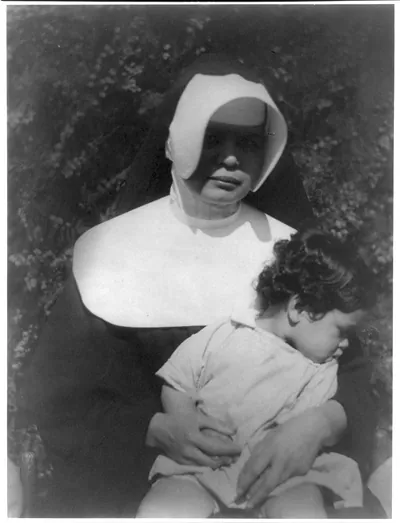 [Nun holding child]