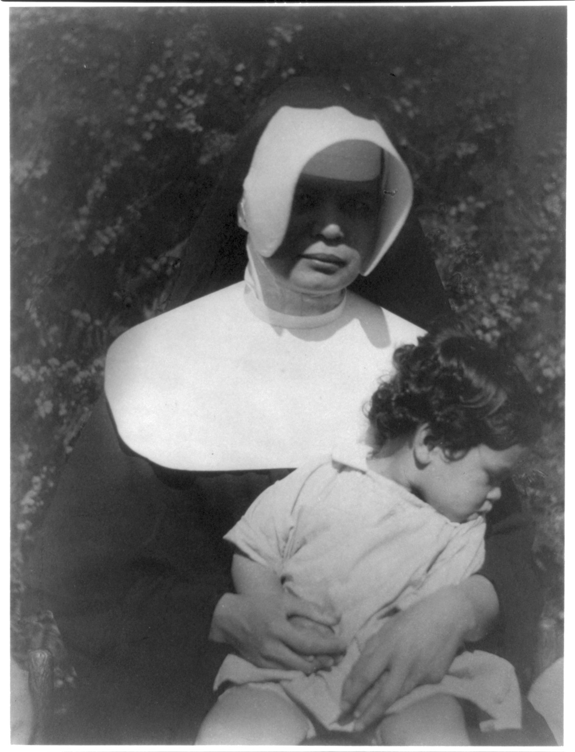 [Nun holding child], [ca. 1930] — historic photograph