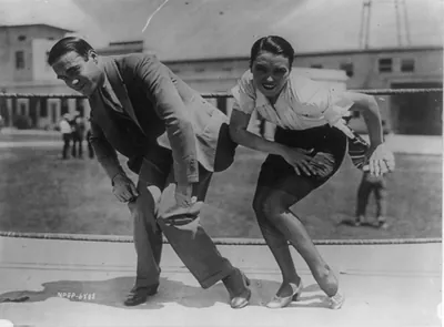Frank Farnum coaching Pauline Starke. And now the Charleston is moving into the movies! Pauline Starke will introduce it to the movie public at large when in the role of a chorus girl in Metro-Goldwyn-Mayer's A Little bit of Broadway" originator of the step gave her first-hand (or foot) instructions"