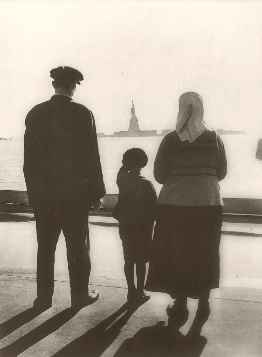 [Immigrant family looking at Statue of Liberty from Ellis Island], [ca. 1930] — historic photograph