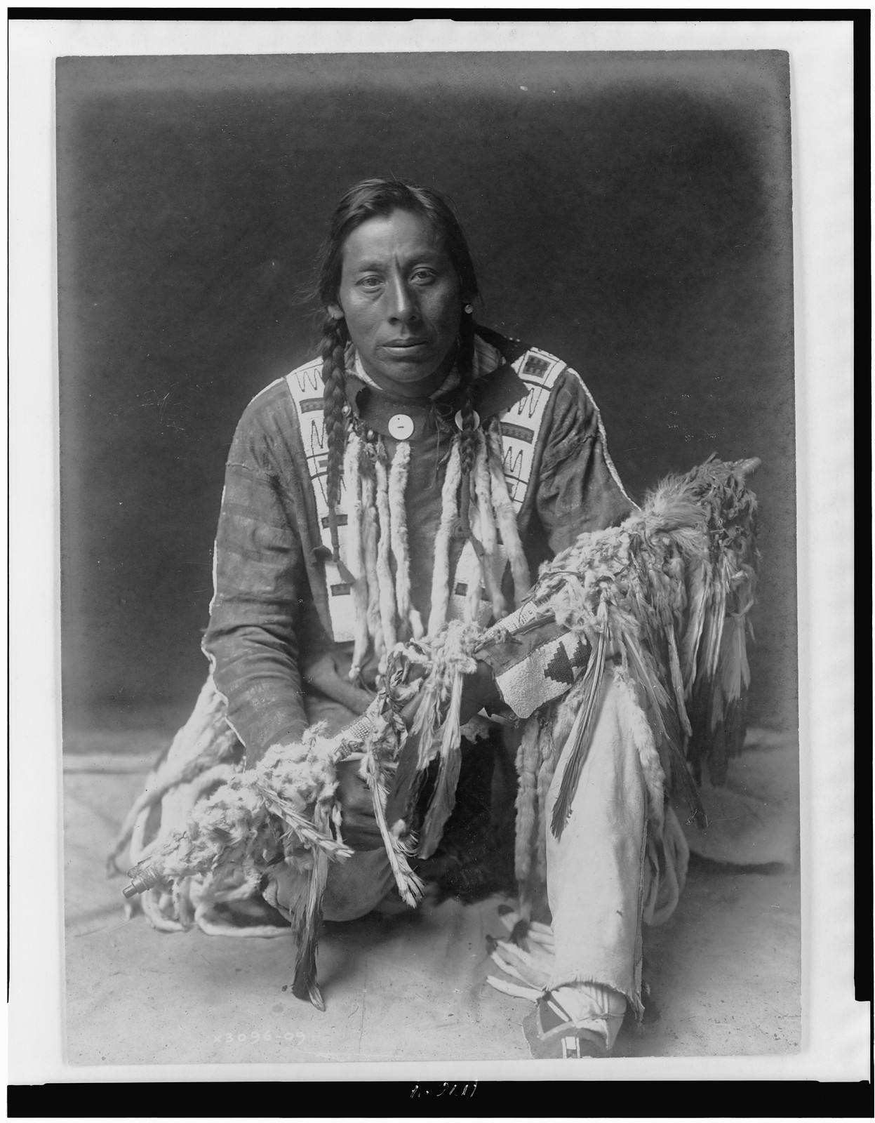 A medicine pipe--Piegan, c1910. — historic photograph