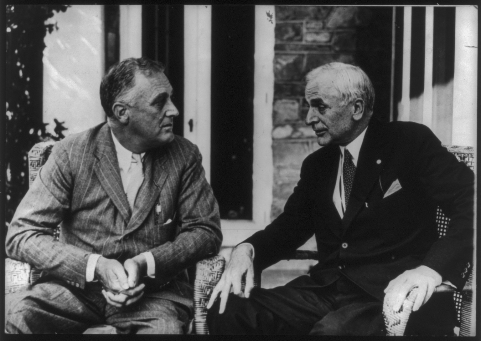 [Pres. Franklin D. Roosevelt and Cordell Hull seated, facing each other, outside of building, Hyde Park] — historic photograph