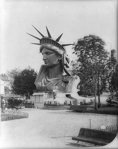 [Head of Statue of Liberty on display in park in Paris]