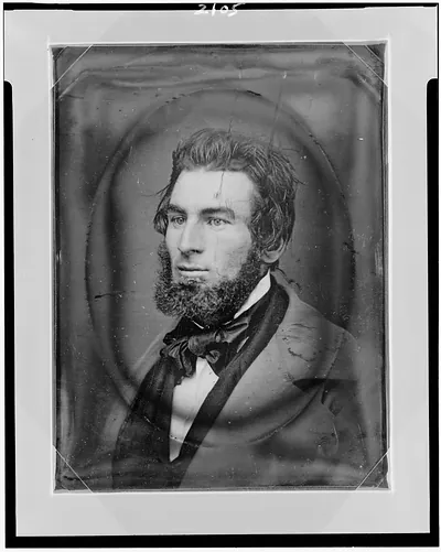 Bearded man in dark suit and bow tie, daguerreotype portrait