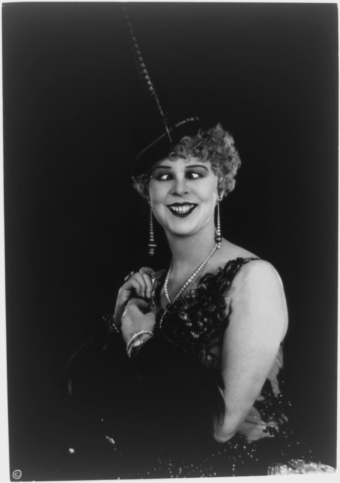 [Woman with eyes crossed wearing elaborate clothing and jewelry], c1927. — historic photograph