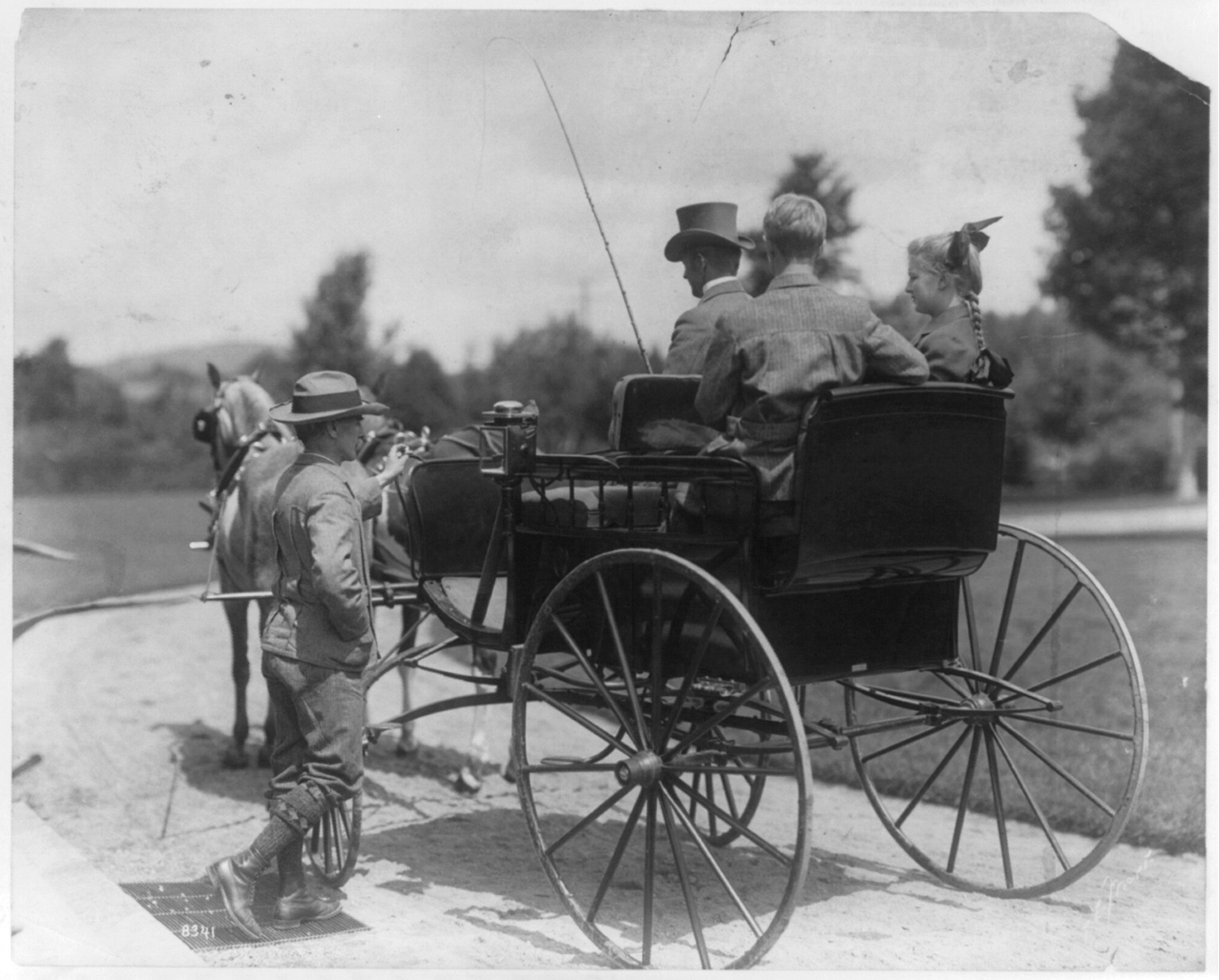 [3 people in horse-drawn carriage and another man getting on the carriage], c1903. — historic photograph