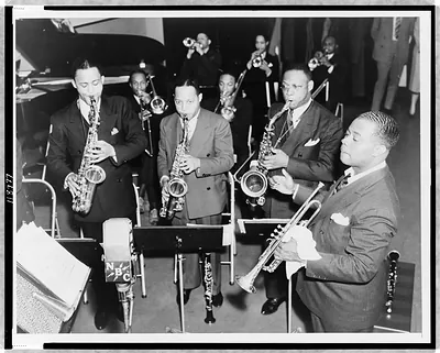 [Louis Armstrong conducting band, NBC microphone in foreground]