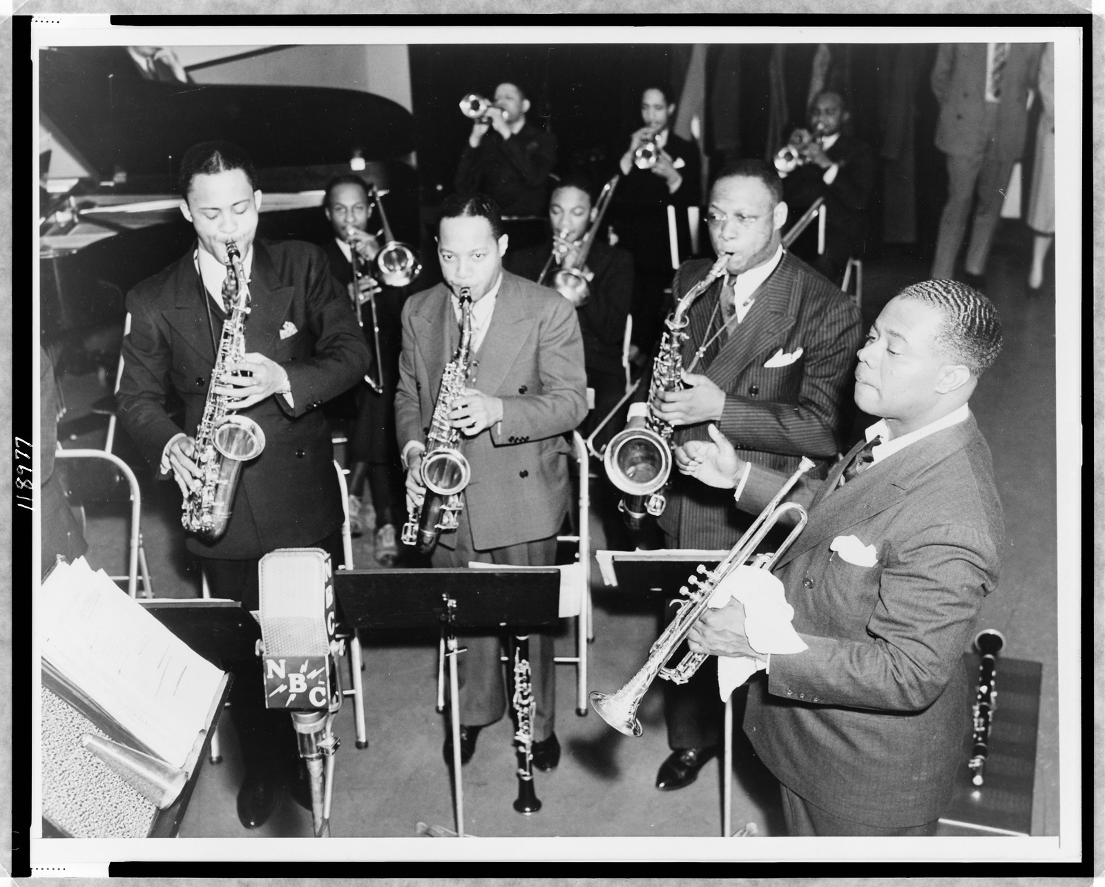 [Louis Armstrong conducting band, NBC microphone in foreground], 1937 — historic photograph