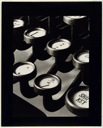 Close-up photograph of typewriter keys, including a SHIFT KEY