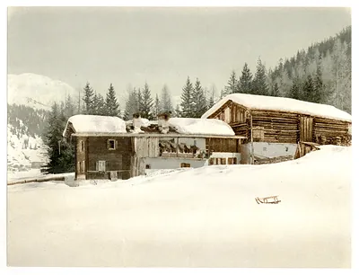Winter scene with log structure and sled