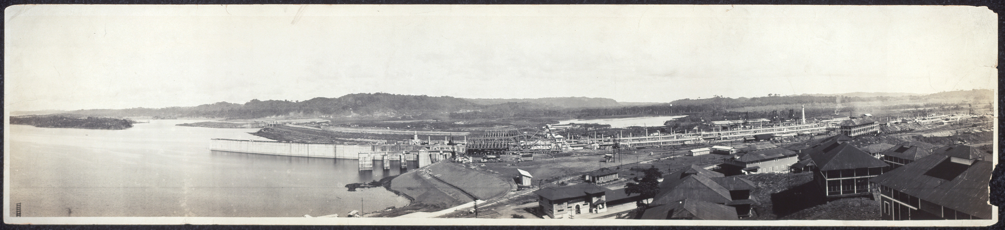 Panoramic view of a lock structure beside a waterway — historic image