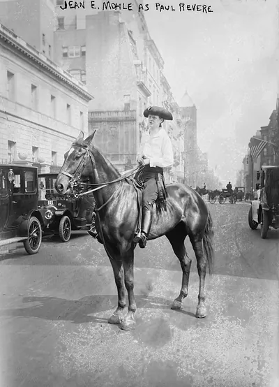 Jean E. Mohile as Paul Revere on horseback in city street