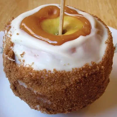 Caramel apple on a stick with brown sugar coating