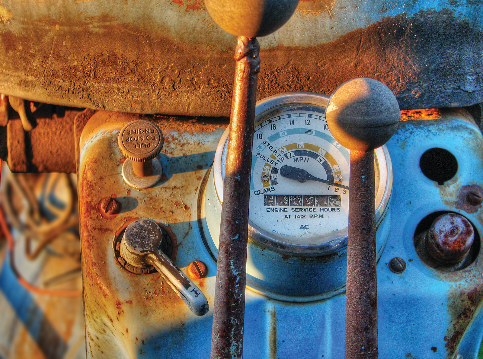 Vintage tractor dashboard with MPH gauge and levers — historic image