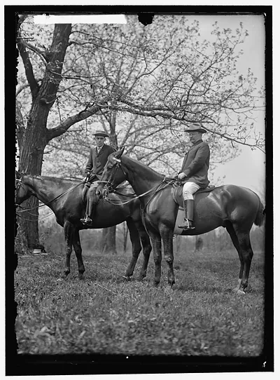 Two men on horseback beneath a leafy tree