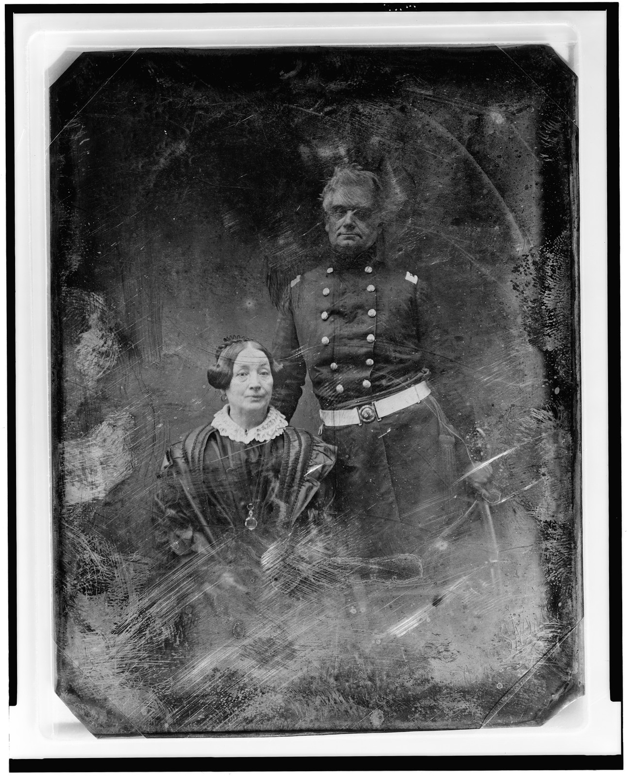 [Military officer and a woman, the officer in uniform, standing, facing front, the woman seated, on the left, nearly full face], [between 1844 and 1860] — historic photograph