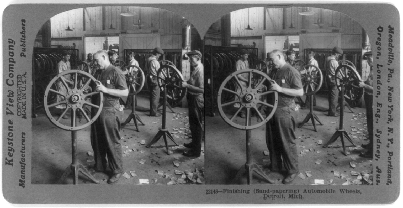 Finishing (sand-papering) automobile wheels, Detroit, Mich., c1917 June 22. — historic photograph